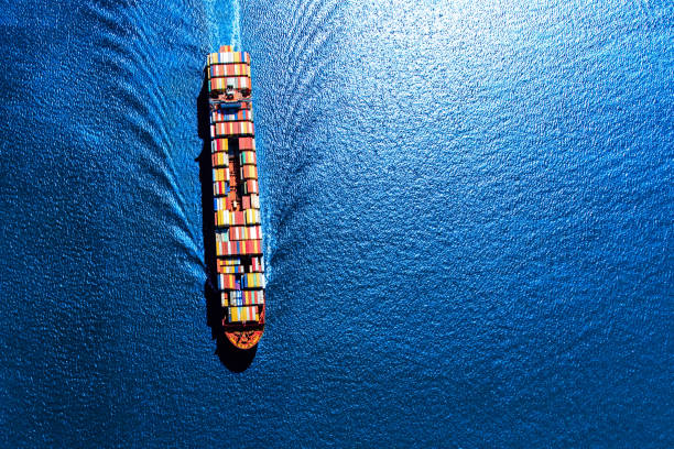 Fully Loaded Container Ship A fully loaded container ship heading toward the Port of Houston from the Gulf of Mexico. container ship stock pictures, royalty-free photos & images