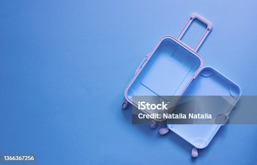 istock Fully opened blue suitcase, on a blue background, top view. Vacation, travel concept. copy space 1366367256