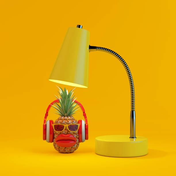 Fun Cartoon Fashion Hipster Cut Pineapple Character with Yellow Sunglasses, Red Headphones and Big Red Lips Under Yellow Modern Desk Lamp. 3d Rendering stock photo