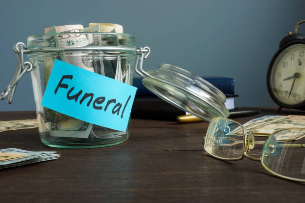 Funeral fund in the glass jar with money. stock photo