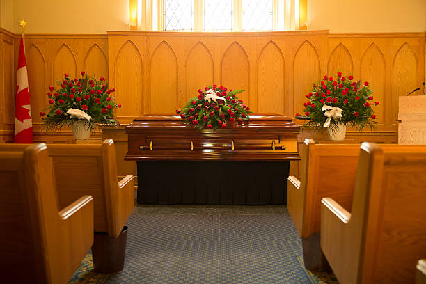 Funeral Coffin with floral arrangement inside a chapel chapel stock pictures, royalty-free photos & images