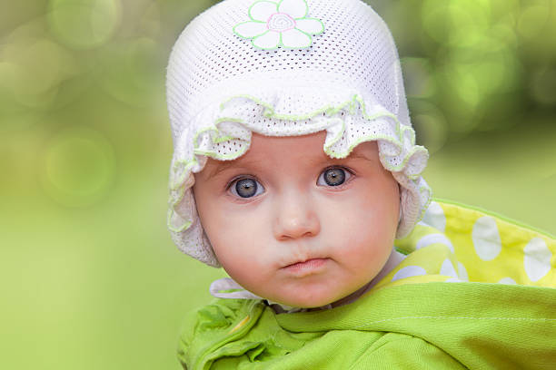 Funny baby girl looking in wide-eyed astonishment stock photo
