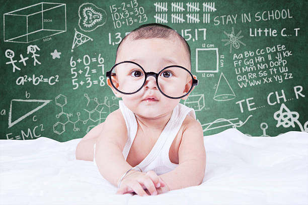 Funny baby with glasses and a doodles background stock photo
