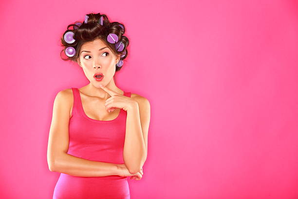 Funny beauty woman with hair rollers stock photo