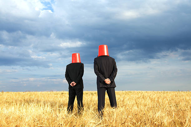Funny businessmen with buckets stock photo