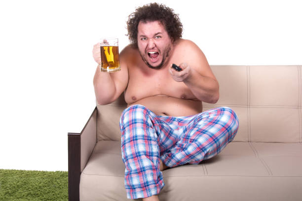 Funny fat man watching tv at home. Isolated background. Big funny man. vlad model photos stock pictures, royalty-free photos & images