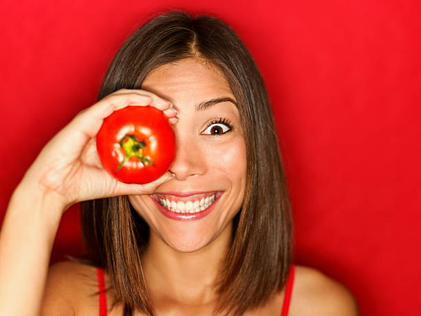 Funny food woman with red tomato stock photo
