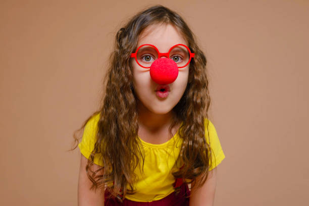 Funny girl in a clown costume. 1 April fool's day. Raffle. Funny girl in a clown costume. 1 April fool's day. Raffle. clown's nose stock pictures, royalty-free photos & images