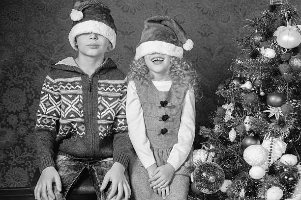 Funny kids at Christmas holiday near decorated christmas tree stock photo
