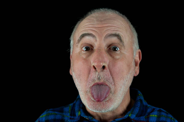 Funny senior sticking out tongue. stock photo