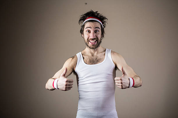 Funny sports nerd posing with thumbs up Funny sports nerd posing Funny sports nerd posing with thumbs up slim stock pictures, royalty-free photos & images