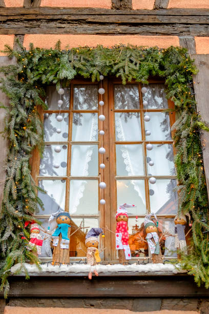 Funny wooden snowmen at the window (Alsace, France) Funny wooden snowmen (Alsace, France) riquewihr stock pictures, royalty-free photos & images