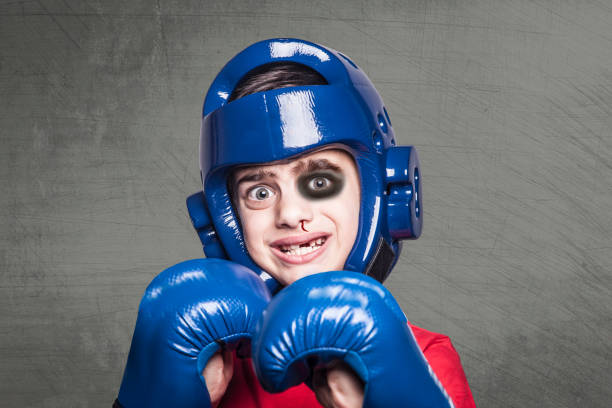 Funny young boxer Funny young beaten fighter with black eye, bleeding nose and broken teeth black eye stock pictures, royalty-free photos & images
