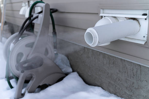 Furnace exhaust pipe blowing out steam in winter stock photo