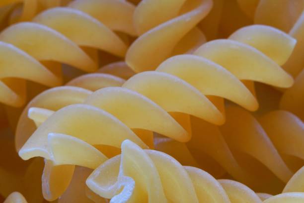 Fusilli dry pasta studio macro closeup stock photo
