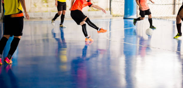 futsal player  trap and control the ball for shoot to goal. soccer players fighting each other by kicking the ball. indoor soccer sports hall - futsal imagens e fotografias de stock