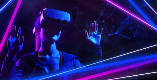 Future game gamefi and entertainment digital technology. Teenager having fun play VR virtual reality glasses sport game metaverse NFT game 3D cyber space futuristic neon colorful background. stock photo