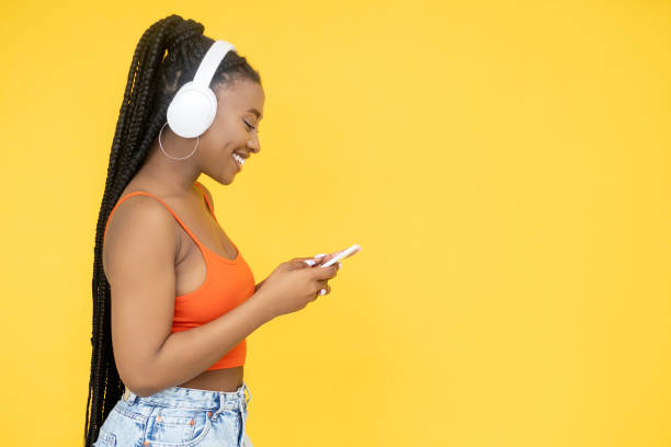 gadget lifestyle music media african woman phone stock photo