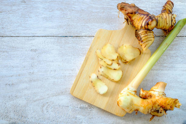 Galangal ingredients in the cooking on a wooden cutting board. stock photo