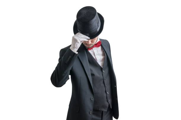 Gallant magician or illusionist in suit is taking off his hat. Isolated on white background.  hats off to you stock pictures, royalty-free photos & images