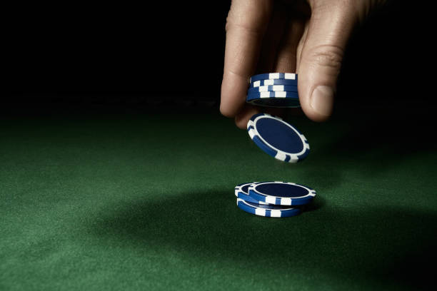 Gambling hand holding poker chips stock photo