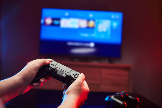 Gamer holding Gamepad, Controller or Videogame Joystick Console in hands. Close up, game concept stock photo