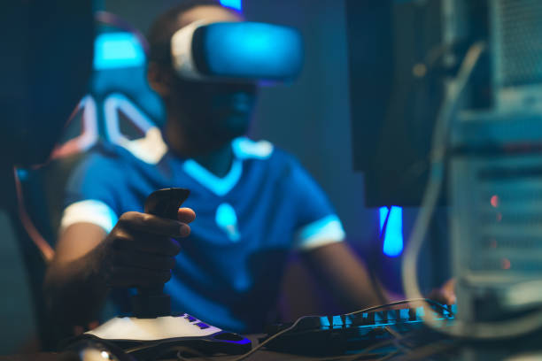Gamers Entertainment Focus on gamers hand operating 3D joystick while playing video game, black man using virtual reality simulator joystick stock pictures, royalty-free photos & images