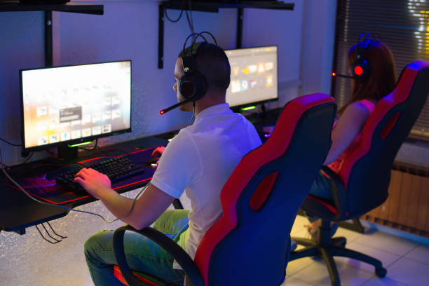 Gamers playing computer games stock photo