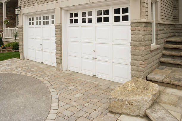 Garage Doors Right side of the double garage in the front of the stone house.  stone house stock pictures, royalty-free photos & images