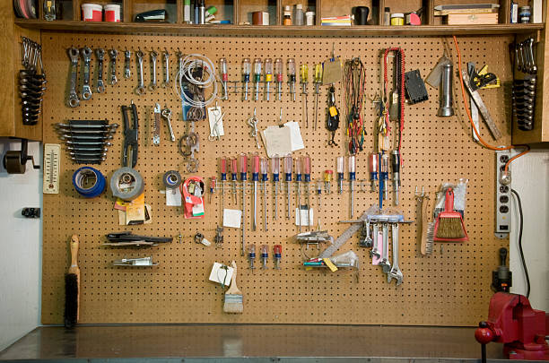 Garage Work Bench "After not finding a workbench photo, I took a picture of my own. (It was a good excuse to clean it off)All logos have been removed from objects." pegboard stock pictures, royalty-free photos & images