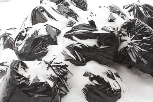 Garbage bags under snow on the street at New York city stock photo
