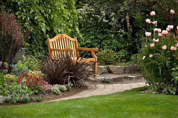 Garden Bench Garden Bench in garden at Roche Harbor resort, San Juan Island, Washington garden path stock pictures, royalty-free photos & images