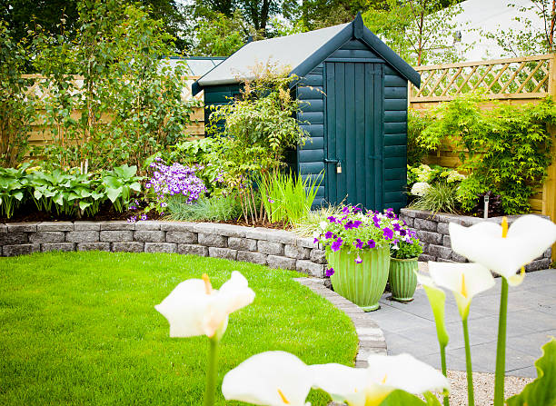Garden shed in a beautiful green garden Back garden tool shed shed stock pictures, royalty-free photos & images