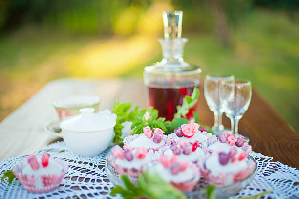 Garden table with cupcakes. stock photo