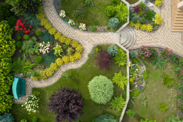 Garden with walkways and green grass. Photo taken from above drone Garden with walkways and green grass. Photo taken from above drone. garden path stock pictures, royalty-free photos & images