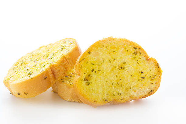 Garlic and herb bread slices Close up Garlic and herb bread slices on white background garlic bread stock pictures, royalty-free photos & images