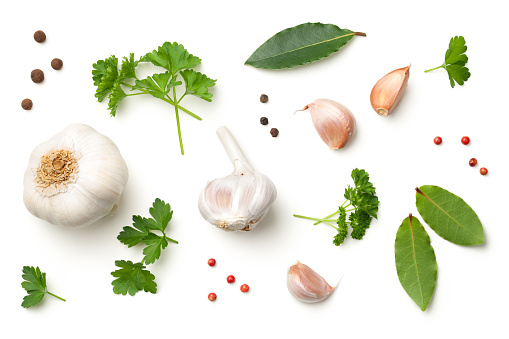 Garlic, bay leaves, parsley, allspice and pepper isolated on white background. Top view