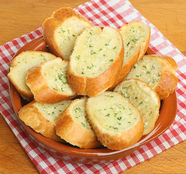 Garlic Bread Baguette Crusty baguette baked with garlic and herb butter. garlic bread stock pictures, royalty-free photos & images