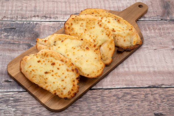 Garlic bread with cheese Garlic bread slices with cheese topping garlic bread stock pictures, royalty-free photos & images