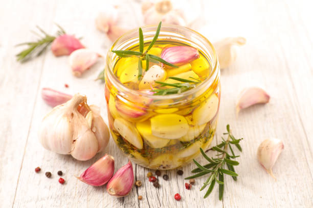 garlic with olive oil and herbs stock photo
