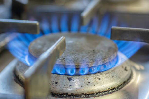 Gas flame burning on kitchen hob stock photo