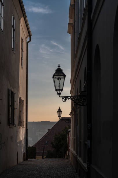 gas lanterns in a narrow street - tadic stockfoto's en -beelden
