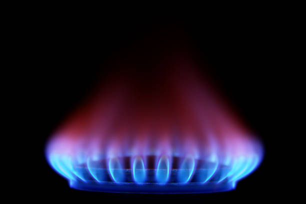 gas stove from side  (blue flames on black) - gas stockfoto's en -beelden