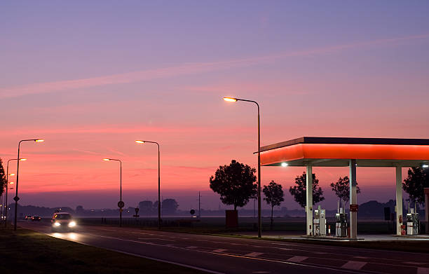 gasstation bei nacht - tankstelle stock-fotos und bilder