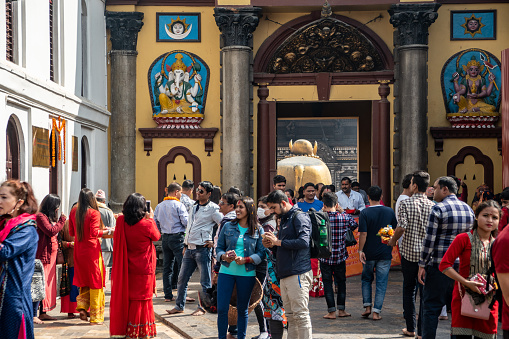 Kathmandu , Nepal - oct 30, 2019: crowd of faithful at the entrance of the Pashupatinath temple, dedicated to Shiva and the bull Nandi. Non-Hindus cannot enter inside the temple.