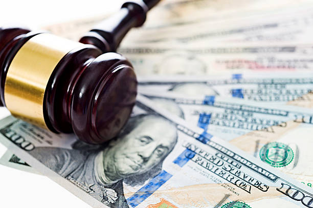 Gavel and money Gavel laying on top of us money. punishment stock pictures, royalty-free photos & images