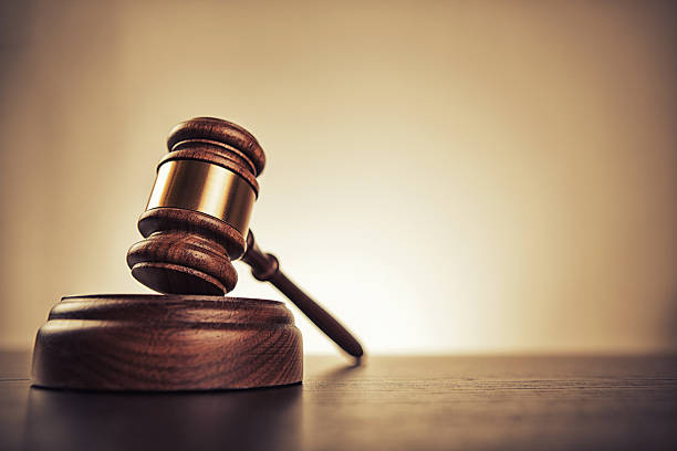 gavel Gavel on desk. Isolated with good copy space. Dramatic lighting. law stock pictures, royalty-free photos & images