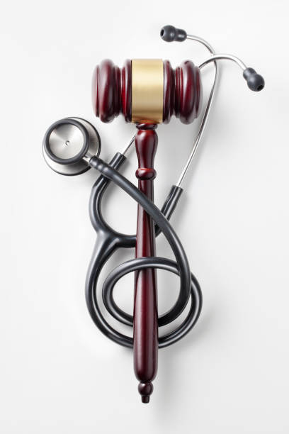 Gavel with stethoscope on white background.