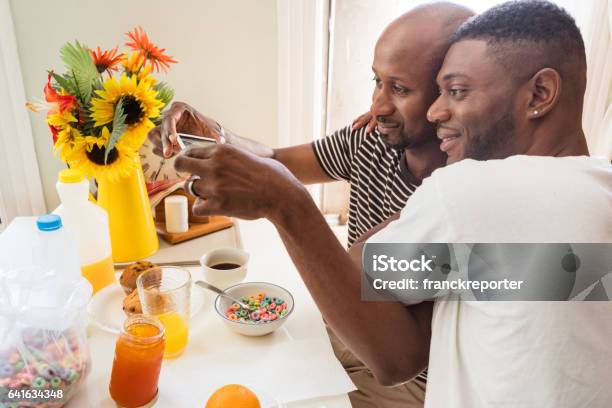 gay couple doing the breakfast and take a pic