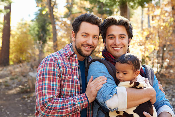 gay masculino casal com bebê caminhada através da floresta de outono nos eua - gay - fotografias e filmes do acervo